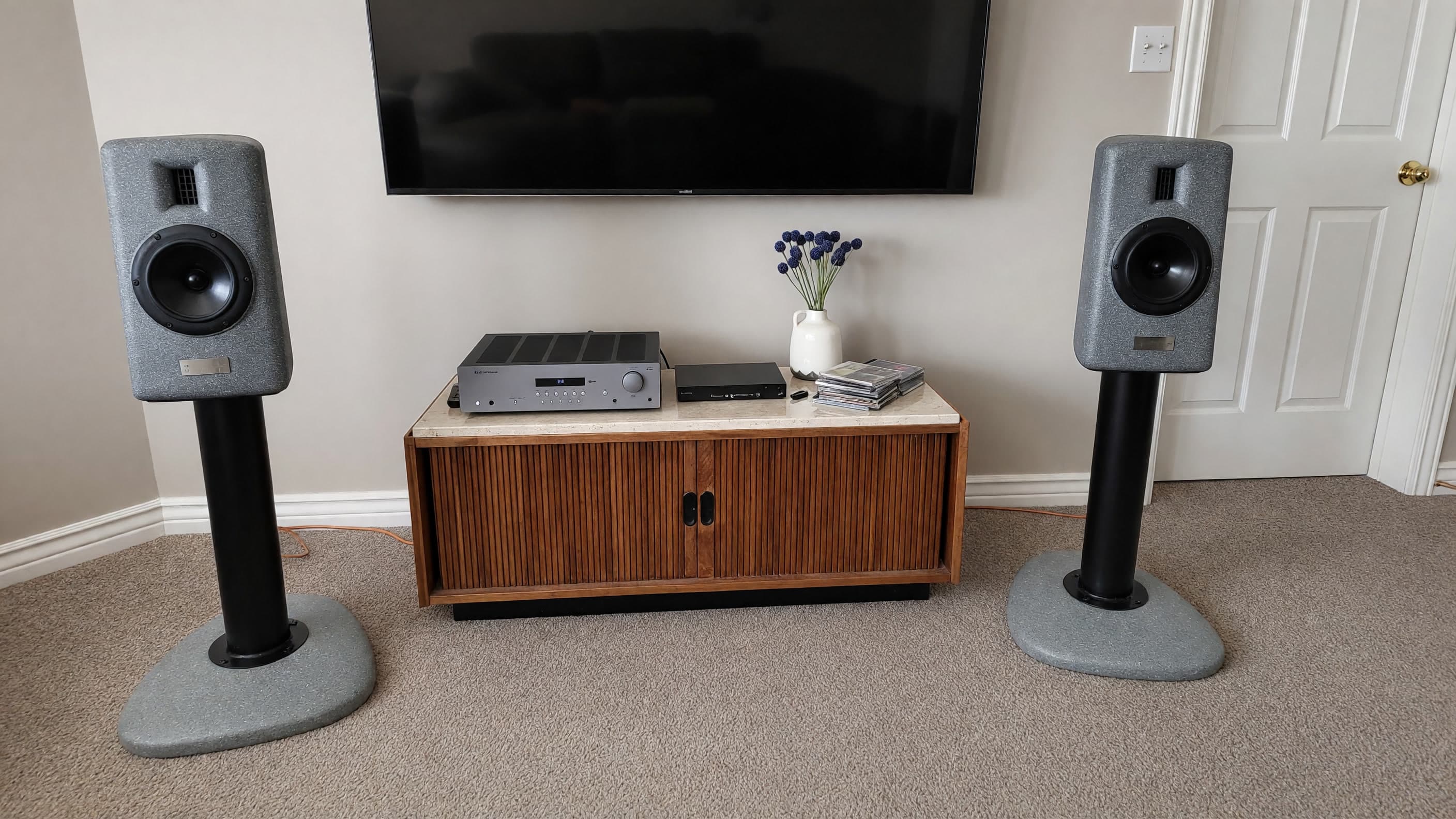 Arcus pair on matching concrete stands in a living room